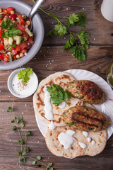 Kofta with flatbread on plate with salad