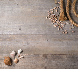 Travel items on wooden table. rope compass and seashells mock-up