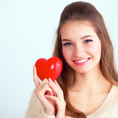 Portrait of beautiful woman hold red heart