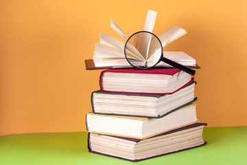 Open book, hardback bookson bright colorful background.