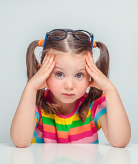 beautiful cute little girl sulking and thinking