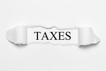 Taxes on white torn paper