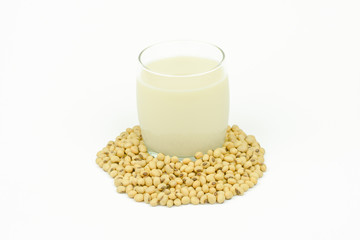 Milk with soy beans on white background.