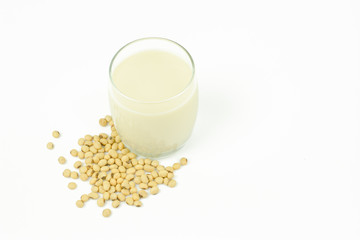 Milk with soy beans on white background.