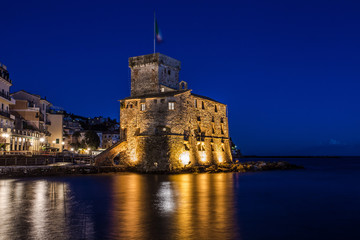 Fototapeta na wymiar The ancient castle on the sea by night, Rapallo, Genoa (Genova), Italy