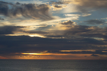 Dramatic evening sky with dark clouds over sea