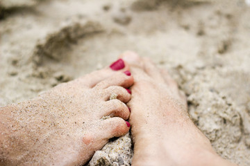 couple feet on the beach love concept