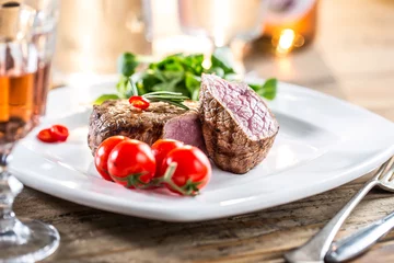 Foto op Plexiglas Steakhouse Beef Steak. Juicy beef steak. Gourmet steak with vegetables and glass of rose wine on wooden table.