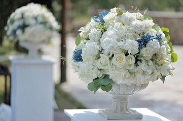 Beautiful wedding bouquet in stone vase closeup, outdoors
