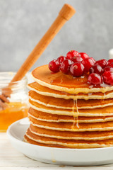 Pancake with honey and fresh berries. Cranberry, cowberry. Gourm