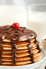 Pancake with chocolate on a white plate. Delicious Breakfast
