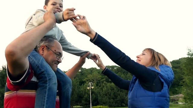 Funny family entertaining anf laughing in park zone. Slow motion.