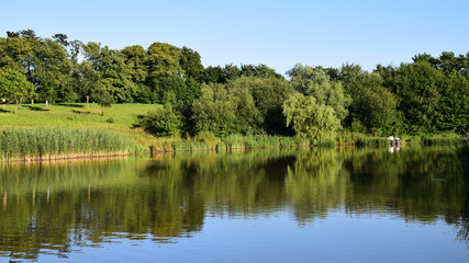 Fototapeta na wymiar Late spring landscape reflected in the lake