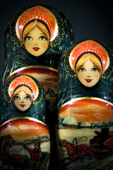 Matryoshka - Pieces of wooden Russian nesting doll isolated on dark background. Still-life picture...