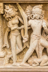 A sculpture of a warrior and nymphs in Abhaneri