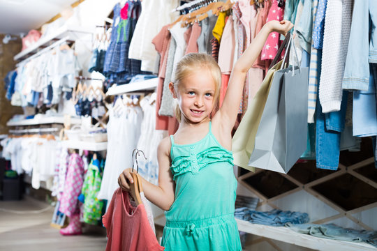 blonde girl in children clothes shop