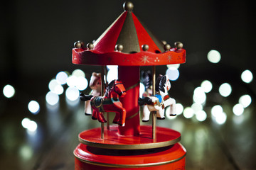 Red carousel toy with blur lights © Nuaestudio