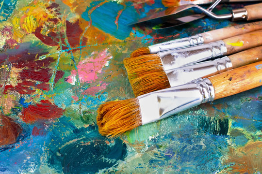 artist's palette with oil paints and brushes