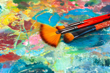 artist's palette with oil paints and brushes