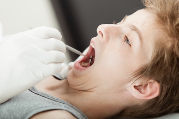 Young boy teeth examination by a dentist