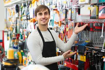 male seller posing at tooling section of household store