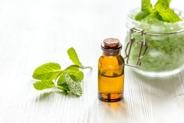 organic cosmetics with herbal extracts of mint on wooden background