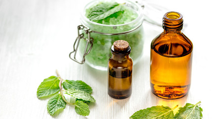 organic cosmetics with herbal extracts of mint on wooden background