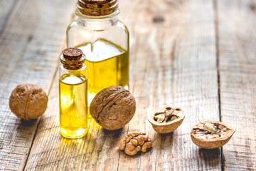 cosmetic and therapeutic walnut oil on wooden background