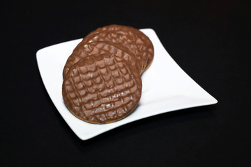 Chocolate biscuits on a white plate