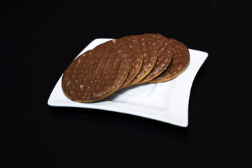 Chocolate biscuits on a white plate