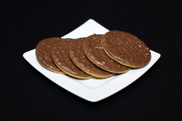 Chocolate biscuits on a white plate