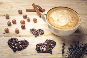 Flavored coffee cappuccino with chocolate in the shape of heart.