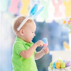 Baby with bunny ears on Easter egg hunt