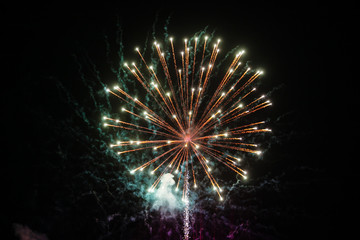 Fireworks explosion at night sky background. Holiday bright salute