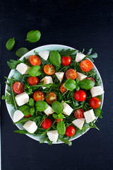 Vegetarian salad with cherry tomato, mozzarella and rucola