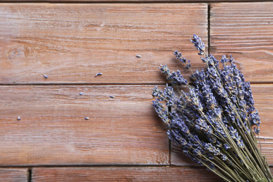 Bunch of lavender flowers on brown wooden background
