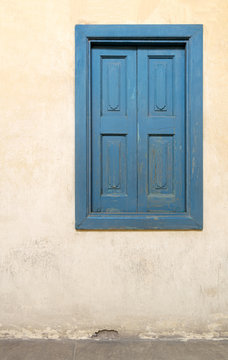 Blue wooden window of a old historic building with vintage plaster wall, Medieval Cairo, Egypt