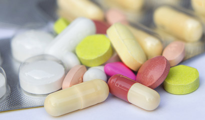 Many pills or medicine closeup on white  background