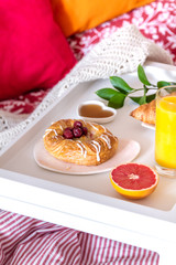 concept of breakfast in bed on tray with juice