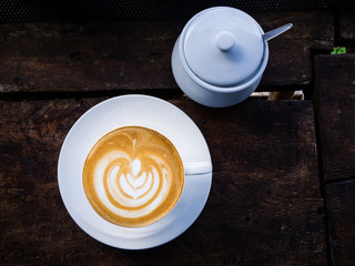 latte coffee on wood with sugar cup 