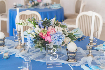 Wedding decor, table setting, floral arrangements in the restaurant