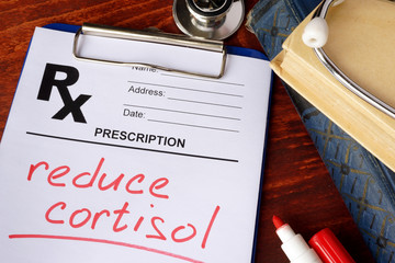 Prescription form with words reduce cortisol. Medical concept.