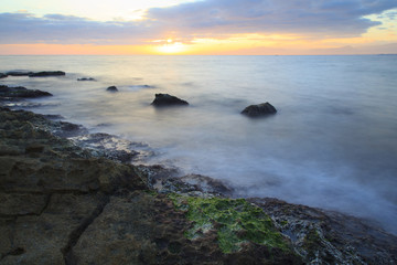 Fototapeta na wymiar Sea coast in a long exposure shot, with blurred water