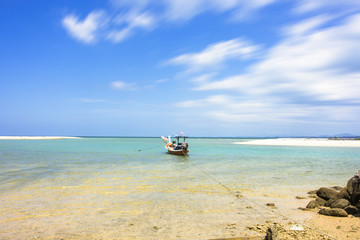 fishing boat on the seascape and cloud moving in blue sky at asi