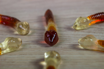 jelly worm with a dark head opposes jelly worms with light Coloured head. Jelly Candy. On the...