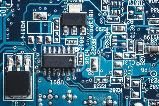 Blue circuit board. Technology and electronics closeup texture.