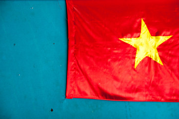 Vietnam Flag of satin fabric on a background of blue wall