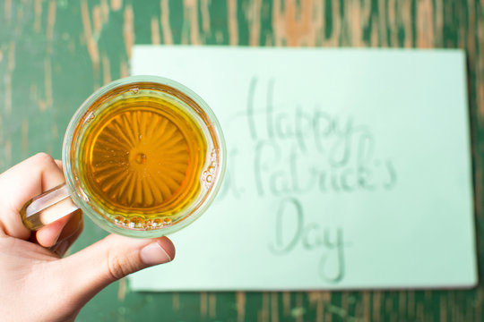 Man having a beer with Happy St Patrick day card