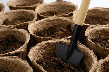 Peat pots with soil and shovel