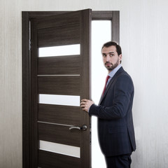 Businessman entering a door